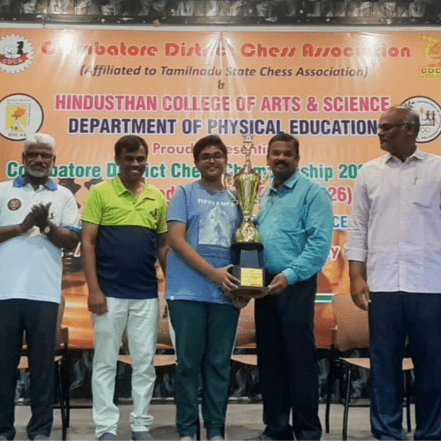 Chess coach guiding students during academy session