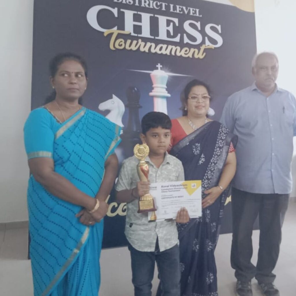 coimbatore chess academy competition results student from Coimbatore chess academy holding trophy