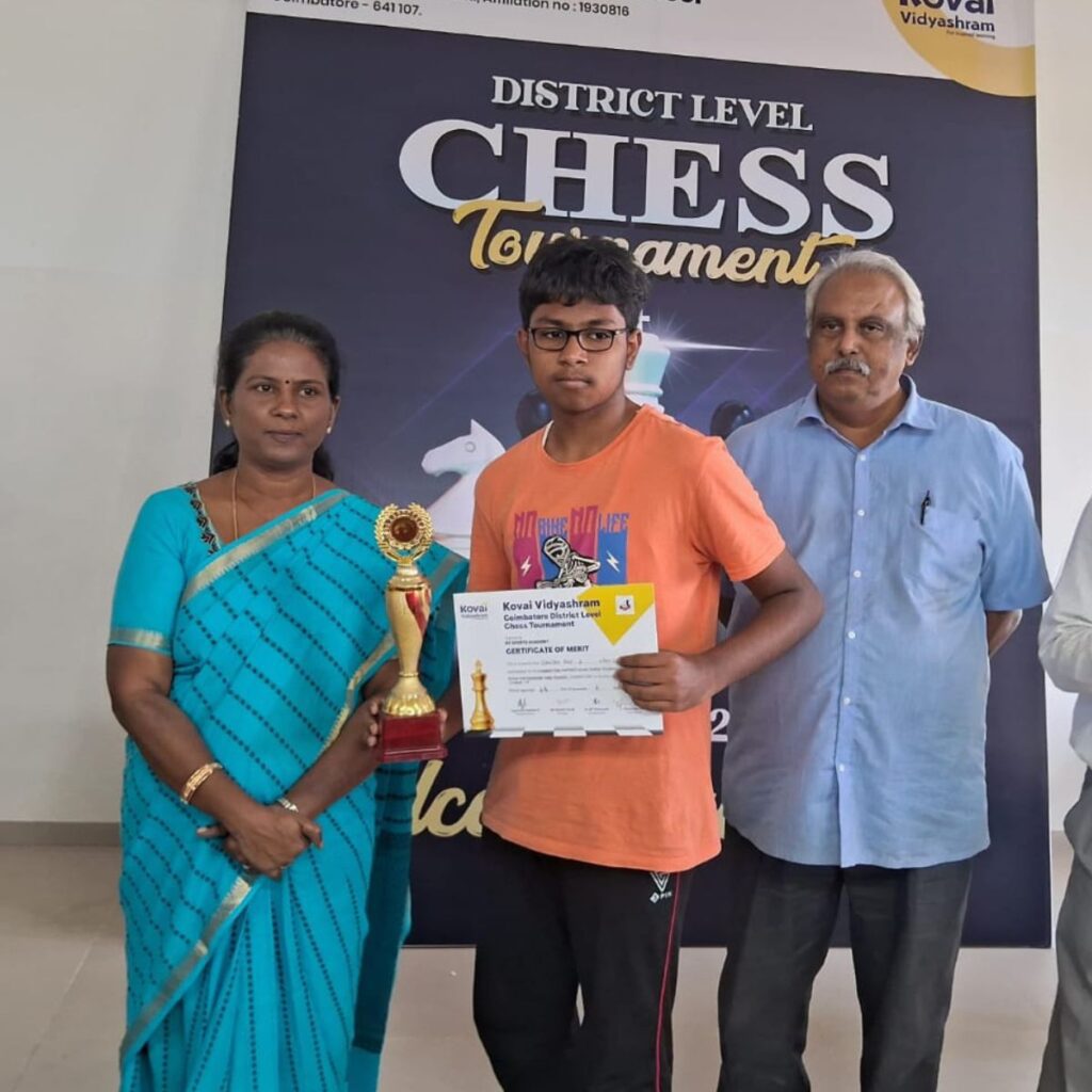 coimbatore chess classes student winning trophy Coimbatore chess student holding trophy